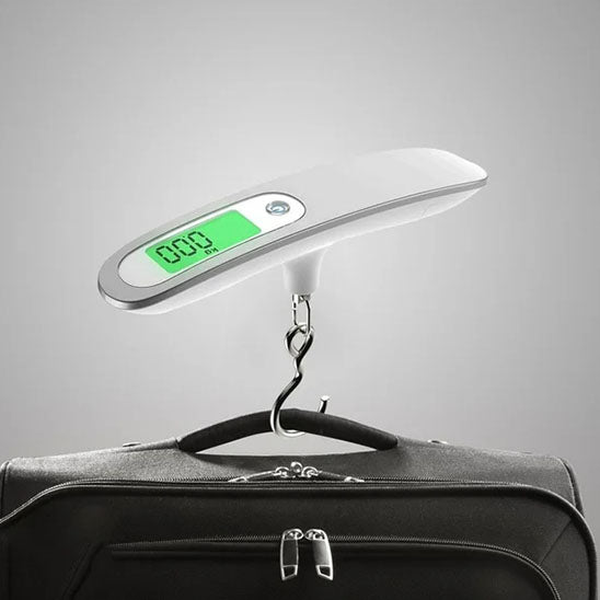 pese bagage numérique à ceinture suspendue au dessus valise noire