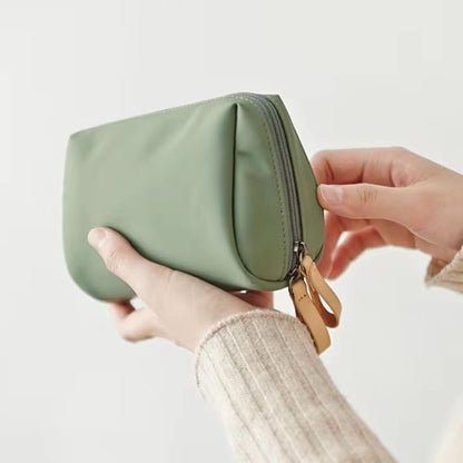 Petite-trousse-de-toilette-et-de-maquillage-femme-pour-le-voyage-verte-dans-les-mains-femme