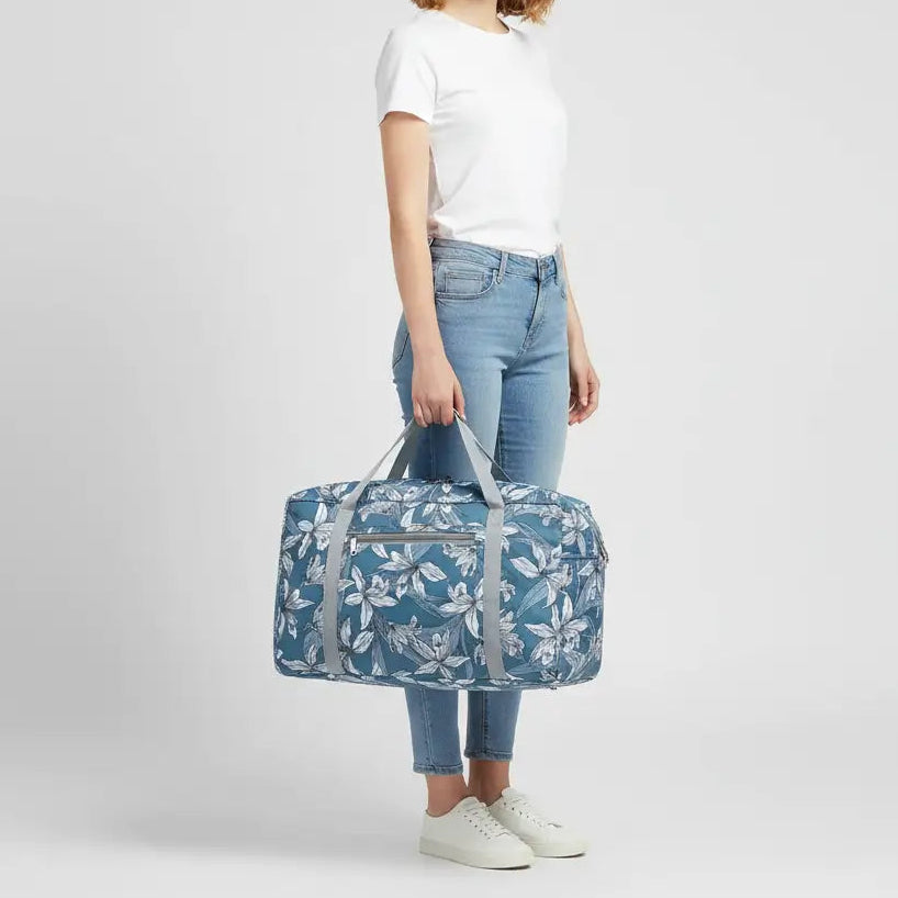 femme qui tient sac de voyage pliant